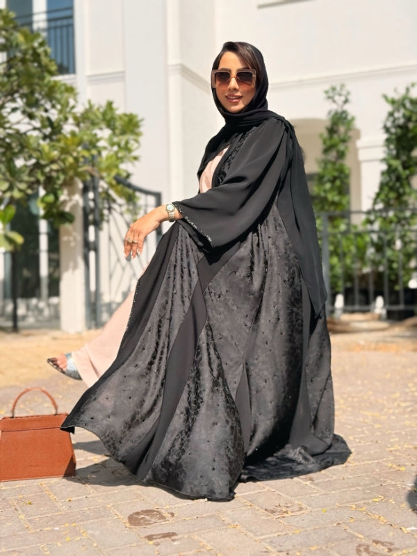 Nyla black self-print & plain fabric abaya, best-selling modest wear in UAE and Saudi Arabia, side view.